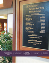 Cast metal donor and directory plaque in a building lobby