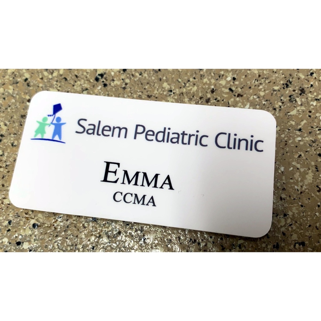 Full color sublimated 1 1/2" x 3" Unisub name badge, matte white, showing thickness and rounded corners